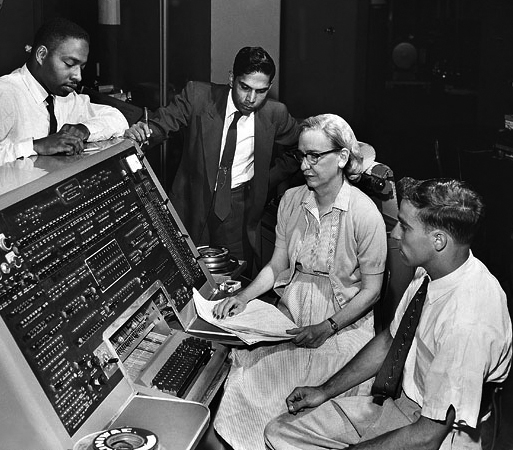 Grace Hopper with other computer scientists, black and white photo